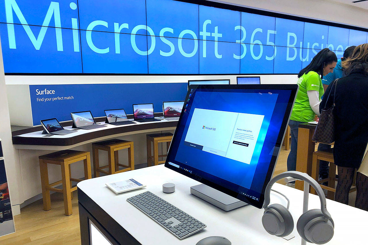 In this Jan. 28 photo, a Microsoft computer is among items displayed at a Microsoft store in suburban Boston. Microsoft said Friday it is permanently closing nearly all of its physical stores around the world. (AP Photo/Steven Senne, File)