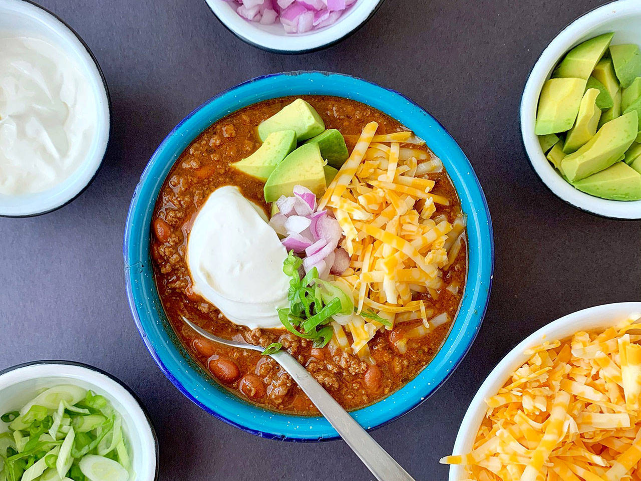 Lots of crunchy, sharp and creamy toppings turn a simple bowl of beef and bean chili into dinner in an instant. (Ben Mims / Los Angeles Times)