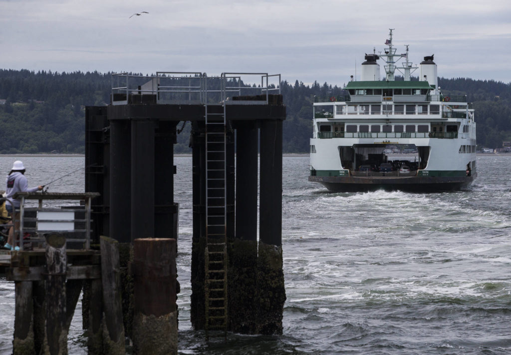 A full ferry pulls away from the dock in Mukilteo. (Olivia Vanni / The Herald)
