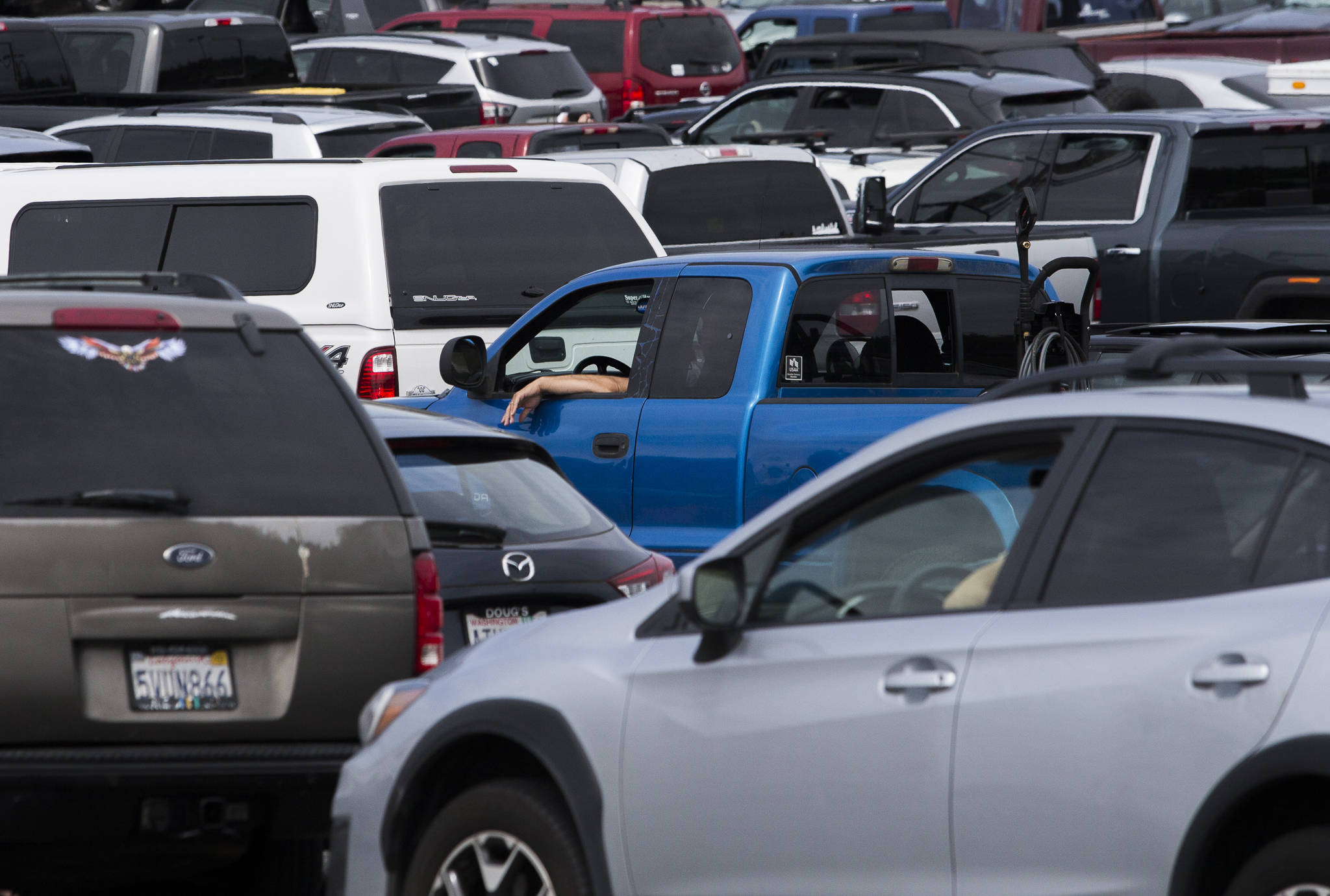 People wait in line for the next ferry to arrive in Mukilteo. (Olivia Vanni / The Herald)