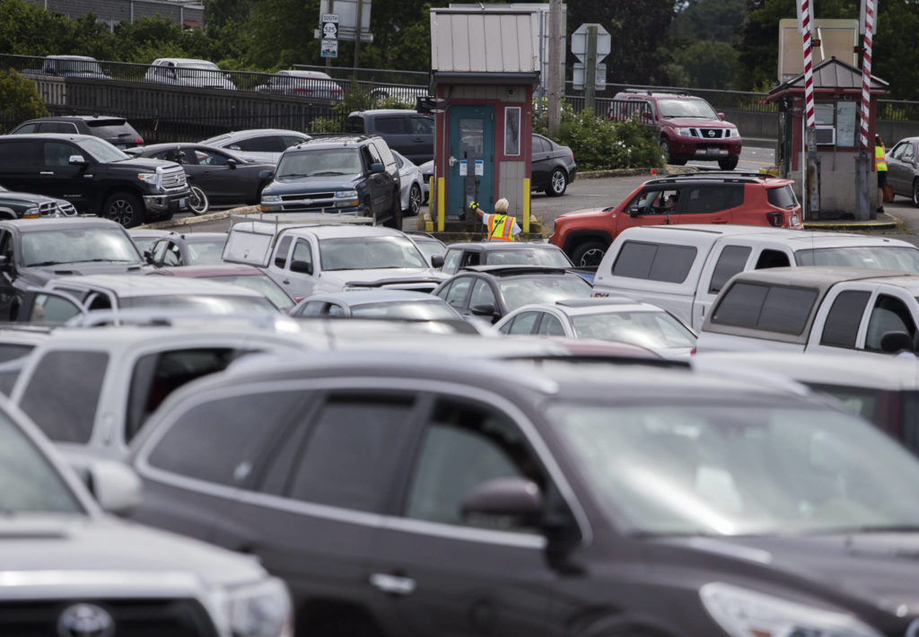 Cars pull into the ferry lines in Mukilteo. (Olivia Vanni / The Herald)
