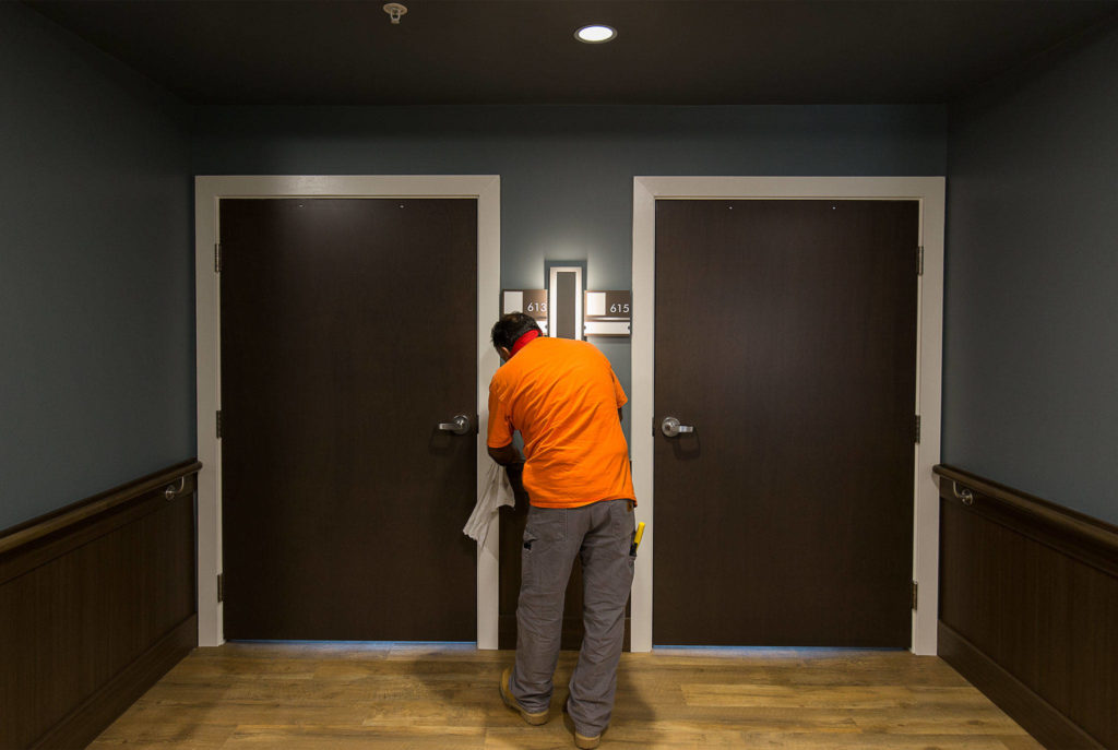 A construction worker polishes a railing at Bethany at Silver Lake on Tuesday in Everett. Bethany of the Northwest, a not-for-profit, is finishing a building project that will add skilled nursing and rehab care with up to 28 new beds. (Andy Bronson / The Herald)
