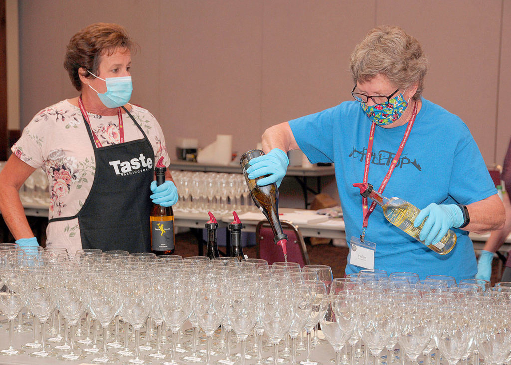 Helen Moir of Chesaw (center) pours a flight of white wine with Lori White (left), of Umatilla, Oregon, and Loris Stupel of Spokane preparing for the next phase at the 2020 Cascadia International Wine Competition in Lewiston, Idaho. (Richard Duval Images)
