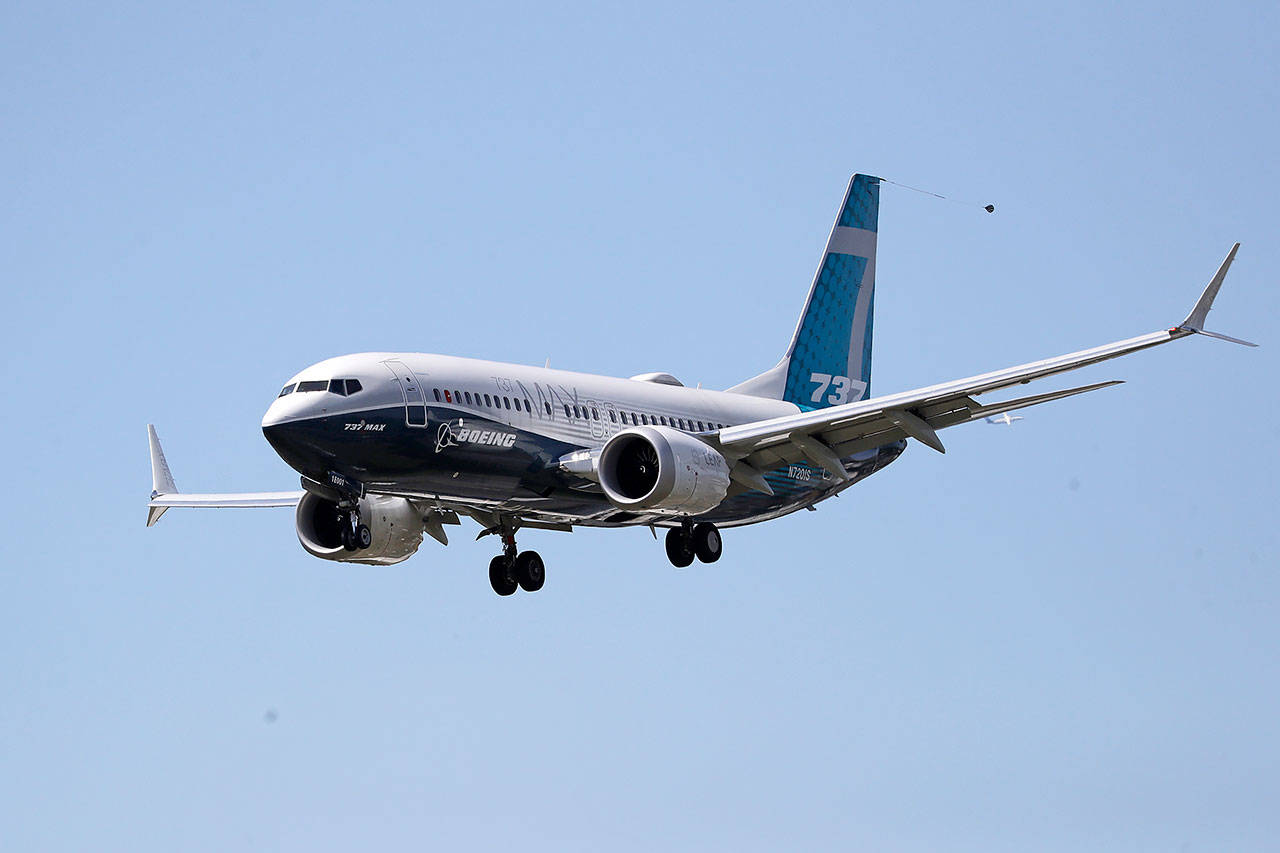 A Boeing 737 Max jet heads to a landing at Boeing Field following a test flight Monday in Seattle. (AP Photo/Elaine Thompson)