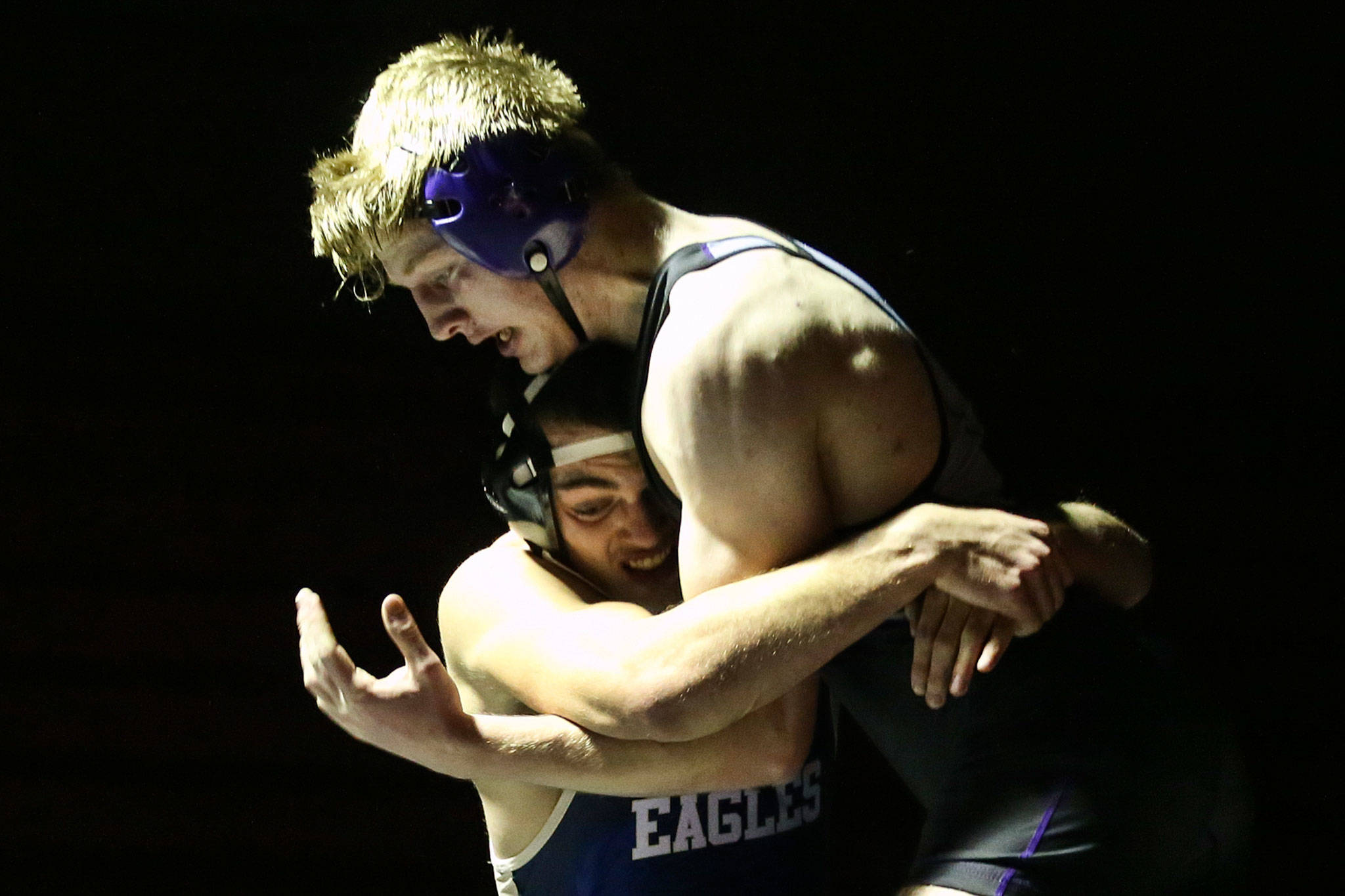 Kamiak’s Stephen Berry (right) wrestles Arlington’s Kristian Fairbanks during a match on Jan. 10, 2019, at Kamiak High School in Mukilteo. (Kevin Clark / The Herald)