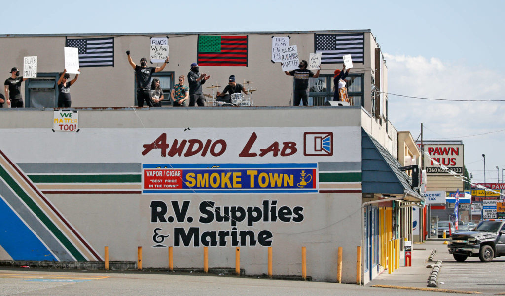 Protesters gather every week on a Marysville rooftop to bring awareness to police brutality. (Kevin Clark / The Herald)
