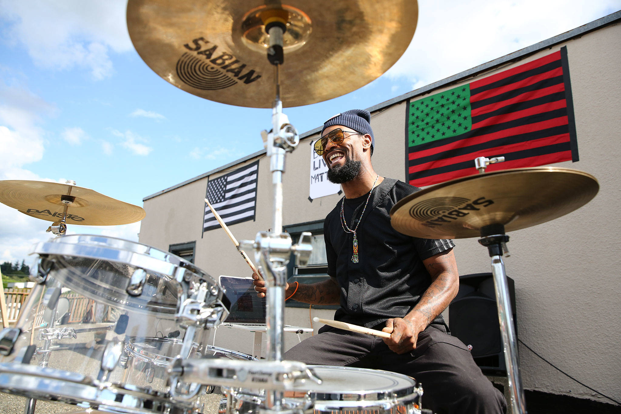 Chris Anderson plays the drums on a rooftop as part of the weekly Black Lives Matter rally in Marysville on July 4. (Kevin Clark / The Herald)