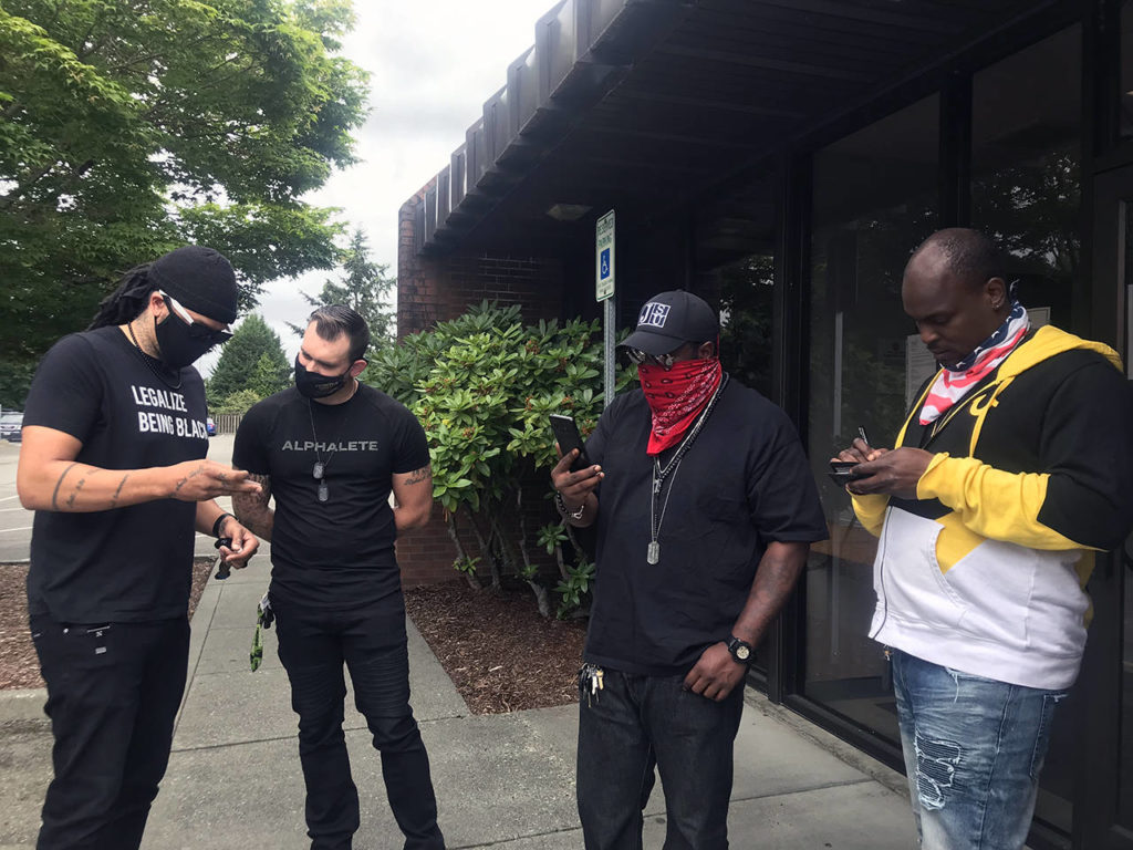 From left, Jordon Jeffries, Ryan Hollifield, Elton Davis and Quinton Harrington stand outside Marysville Municipal Court before Davis’ hearing on July 9. (Stephanie Davey / The Herald)
