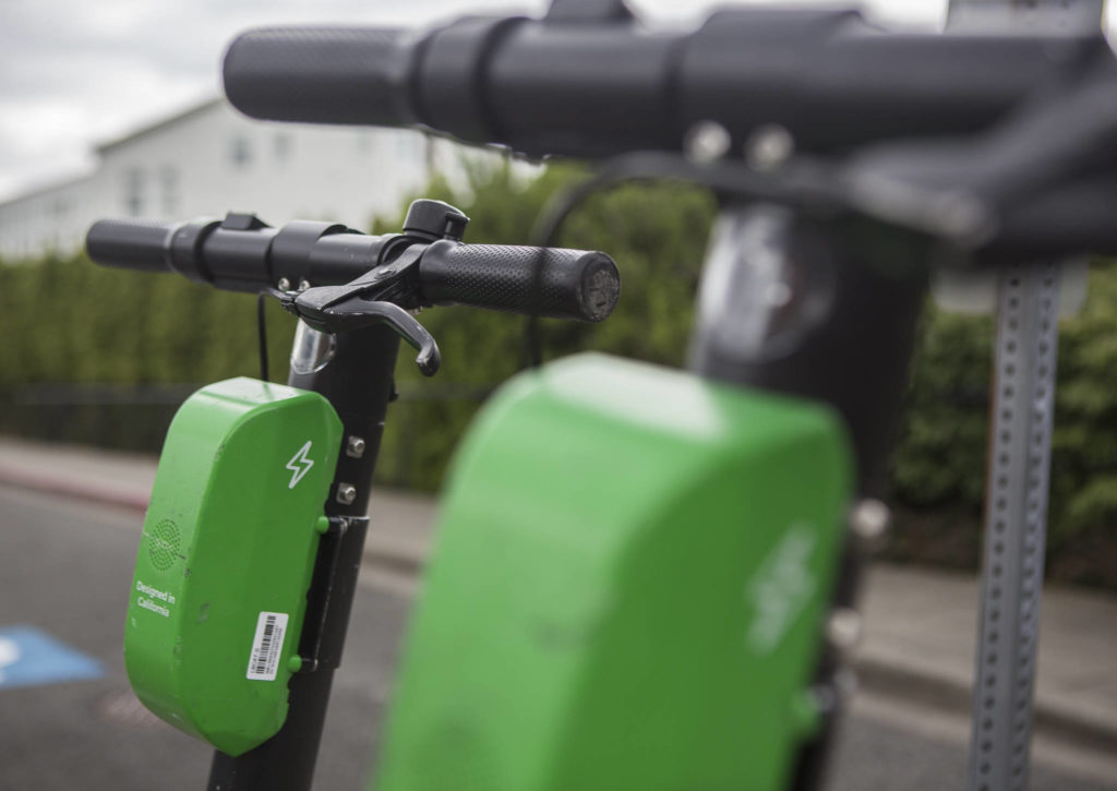 A pair of Lime scooters are seen in front of Pop Keeney Stadium on Wednesday in Bothell. (Olivia Vanni / The Herald)
