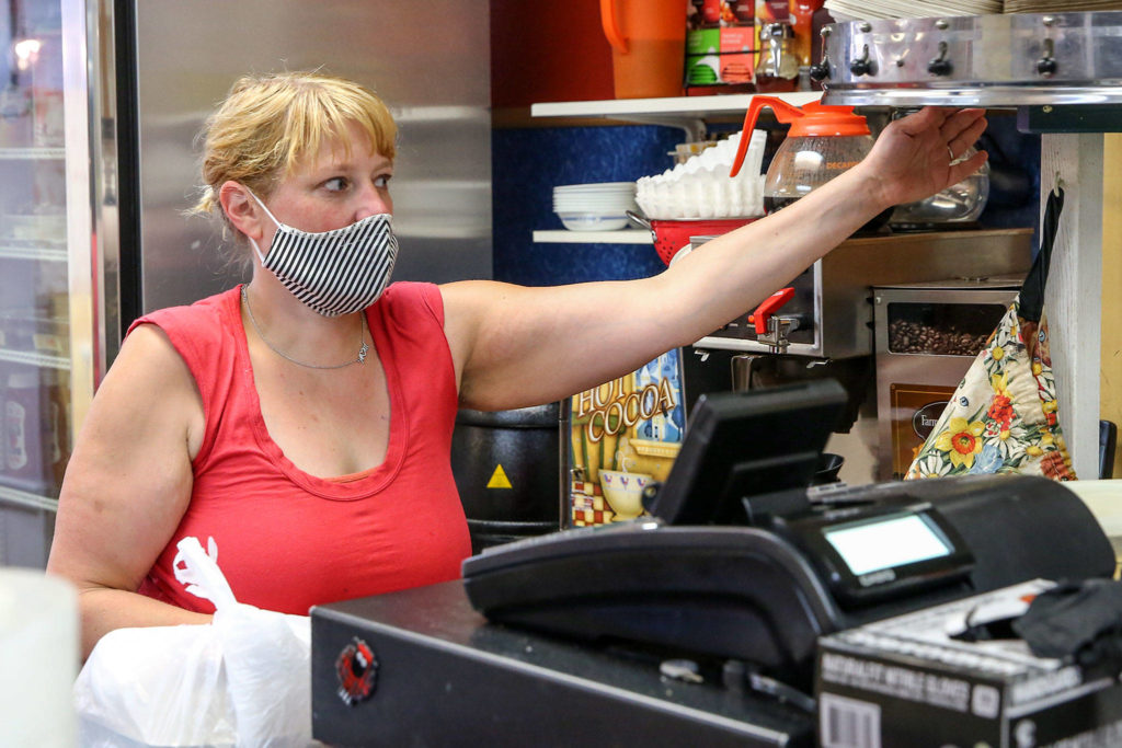 July Peterson places an order at Kate’s Greek & American Deli Friday afternoon in Everett. (Kevin Clark / The Herald)
