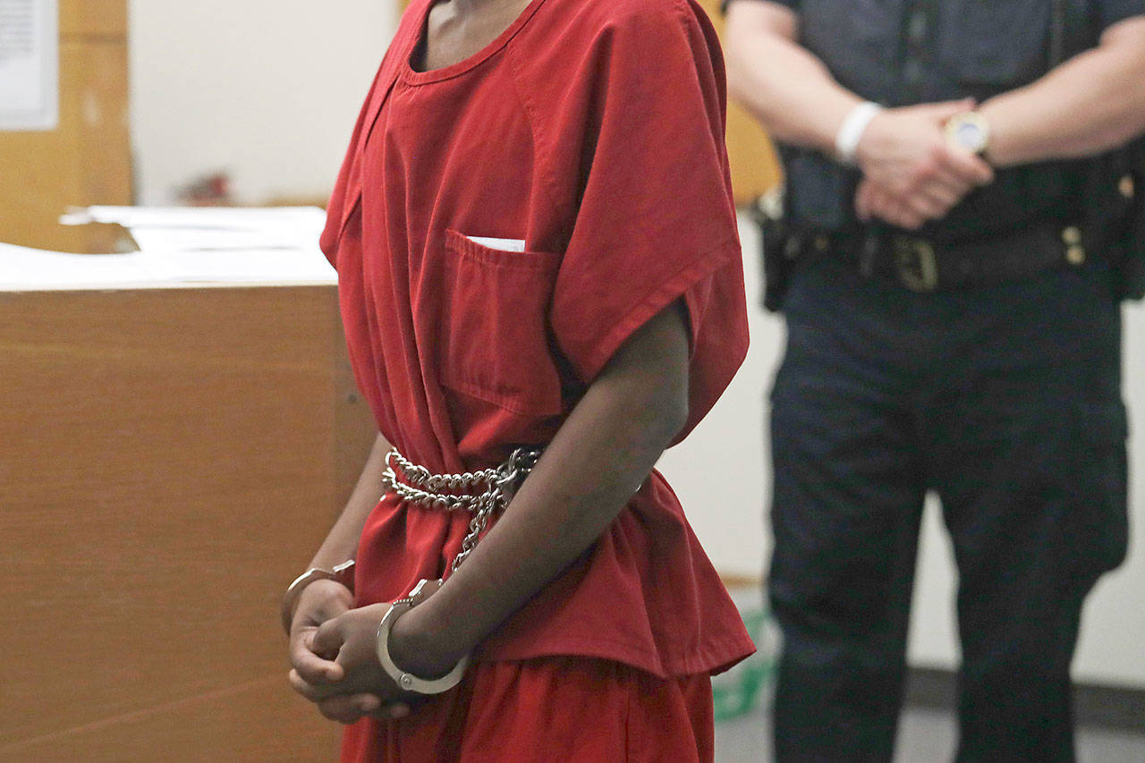 Dawit Kelete wears handcuffs chained to his waist as he walks into a court appearance Monday in Seattle. Kelete is accused of driving a car onto a closed Seattle freeway and hitting two protesters, killing one, over the weekend. (AP Photo/Elaine Thompson)