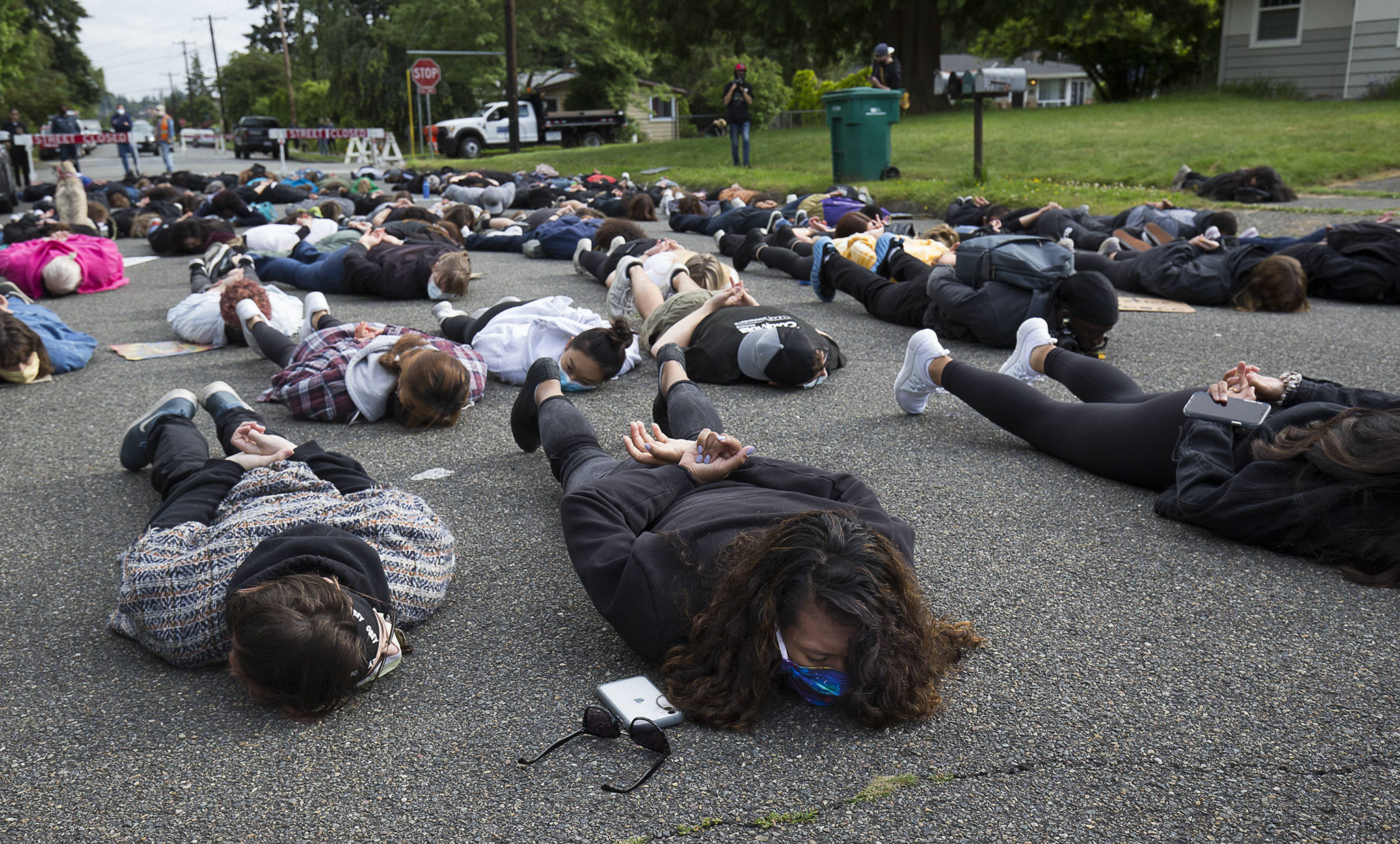 More than 100 people lay on the road for eight minutes and 46 seconds, the time it took George Floyd to die, in the Blackout Tuesday Protest at Lynnwood City Hall on Tuesday. (Andy Bronson / The Herald)