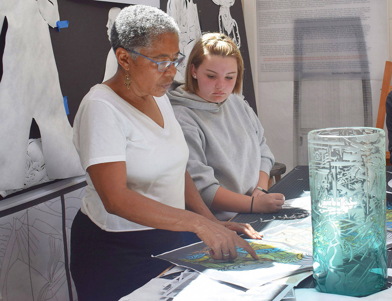 Seattle artist Barbara Earl Thomas and Treehouse participant Ericka work together on an art project Ericka graduated from high school this year and plans to finish her associates degree at Bellevue College and transfer to a university to study to become a youth advocate lawyer. (Treehouse)