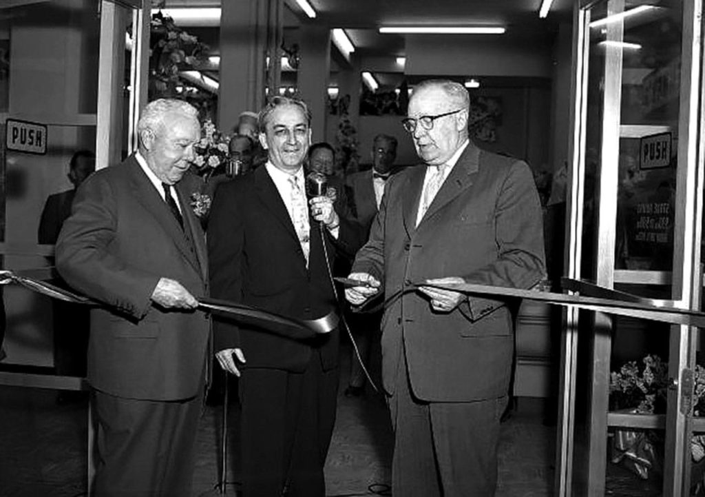 Lew V. Day (left) spearheaded the founding of the Everett Central Lions Club 100 years ago in 1920. A former Everett Penney’s store manager who became executive vice president of the J.C. Penney Co., Day is shown here in 1957 with store manager Donald Gillette as then-Everett Mayor George Culmback snips a ribbon to open a remodeled J.C. Penney store. (Herald file)
