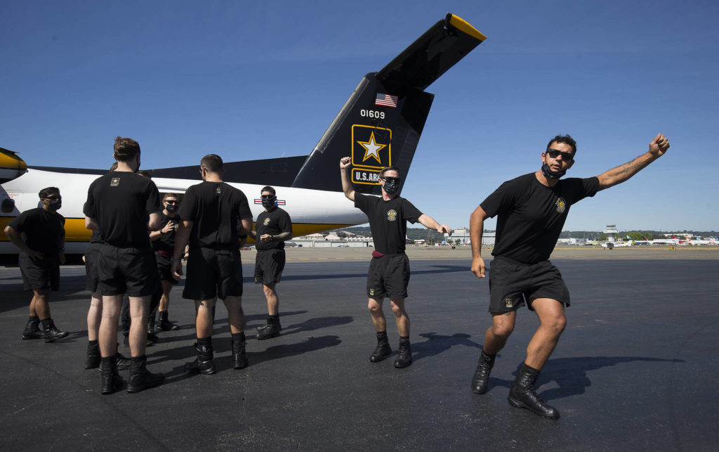 Members of the U.S. Army Golden Knights parachute team go through their performance on the ground before parachuting into Everett. (Andy Bronson / The Herald)
