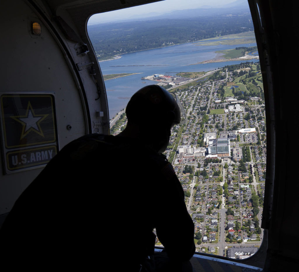 A member of the U.S. Army Golden Knights looks at the landing site at Providence Regional Medical Center. (Andy Bronson / The Herald)
