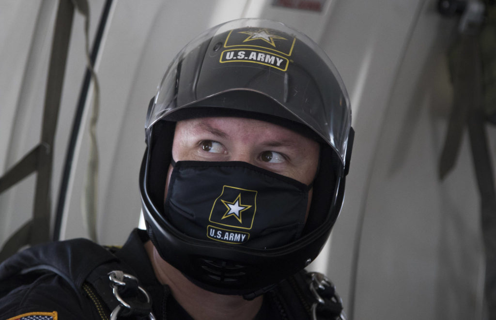 Wearing a mask under his helmet, Houston Creech and the rest of the U.S.Army Golden Knights gets ready to parachute into Everett. (Andy Bronson / The Herald)
