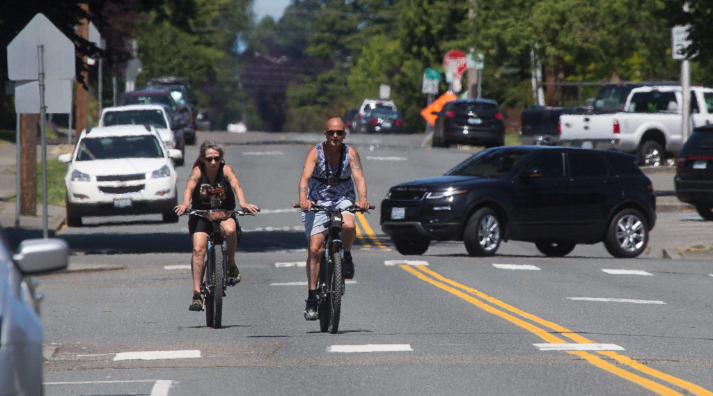People bike along Hoyt Avenue on Wednesday in Everett. The city is preparing to close four road segments to through traffic as part of its Healthy Streets Program, including Hoyt Avenue between 19th Street along Everett Avenue. (Andy Bronson / The Herald)
