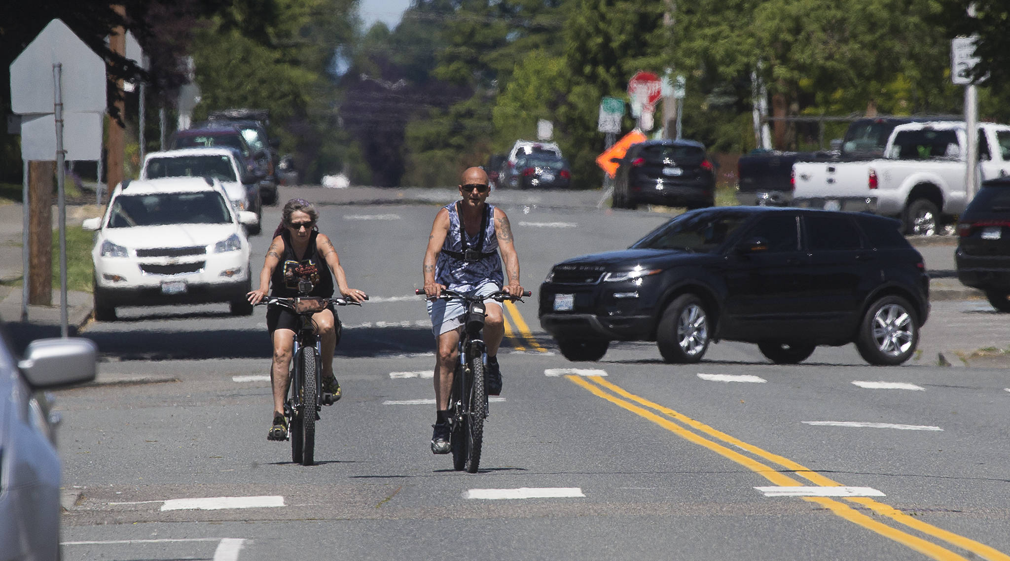 People bike along Hoyt Avenue on Wednesday in Everett. The city is preparing to close four road segments to through traffic as part of its Healthy Streets Program, including Hoyt Avenue between 19th Street along Everett Avenue. (Andy Bronson / The Herald)