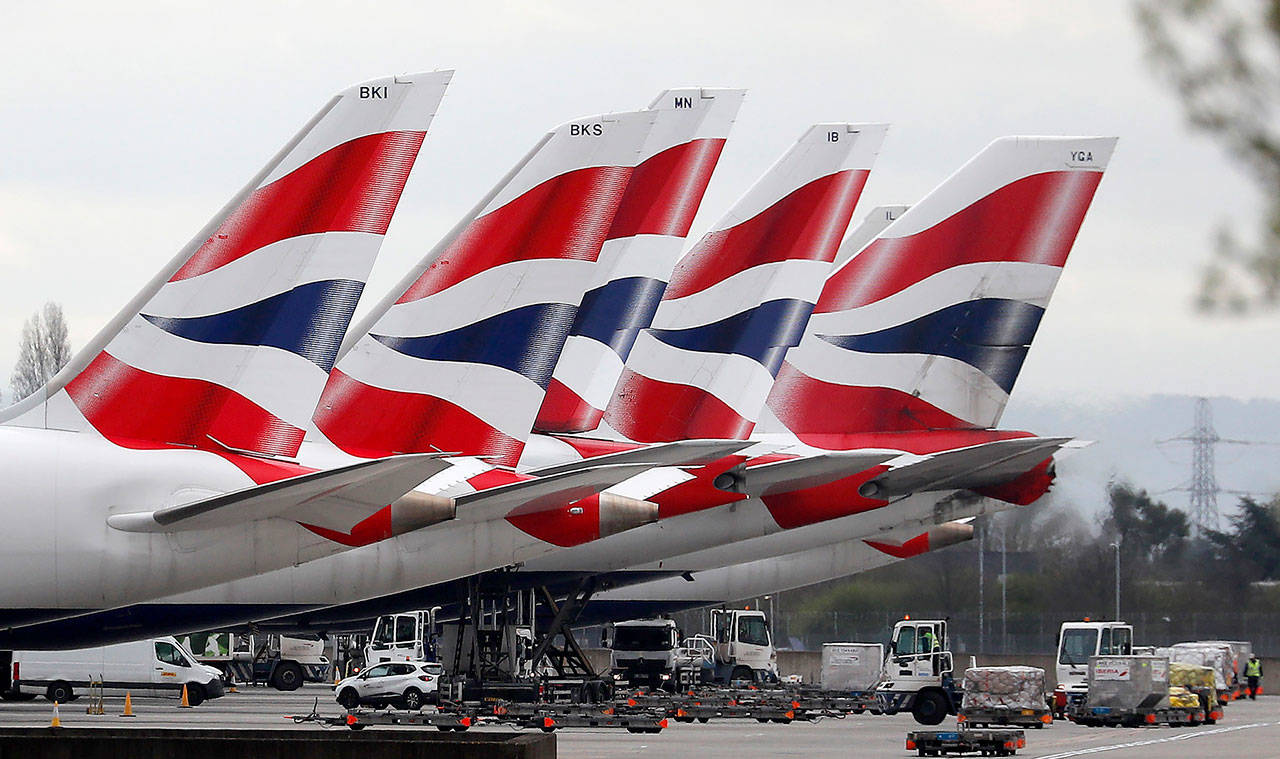 In this March 18 photo, British Airways planes sit parked at Terminal 5 Heathrow airport in London. (AP Photo/Frank Augstein, File)