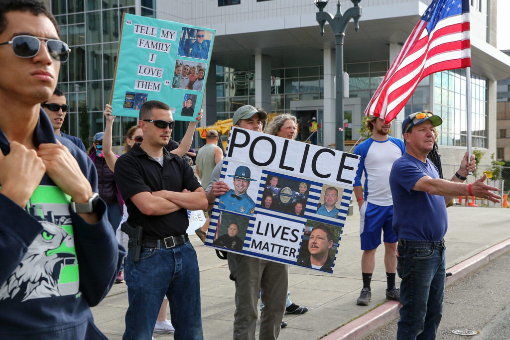Supporters of law enforcement and first responders rally confront counter protesters Friday at the Snohomish County Plaza in Everett on July 17, 2020. (Kevin Clark / The Herald)

