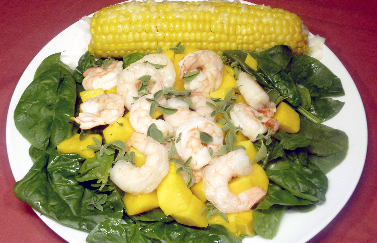 Florentine shrimp mango salad with sweet corn on the cob also can be made with peaches, plums or pineapple. (Linda Gassenheimer / Tribune News Service)