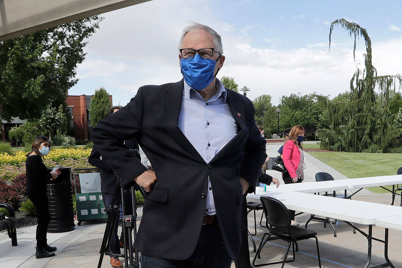 In this June 16 photo, Washington state Gov. Jay Inslee talks about the coronavirus outbreak following a briefing at Yakima Valley College. (AP Photo/Elaine Thompson, file)
