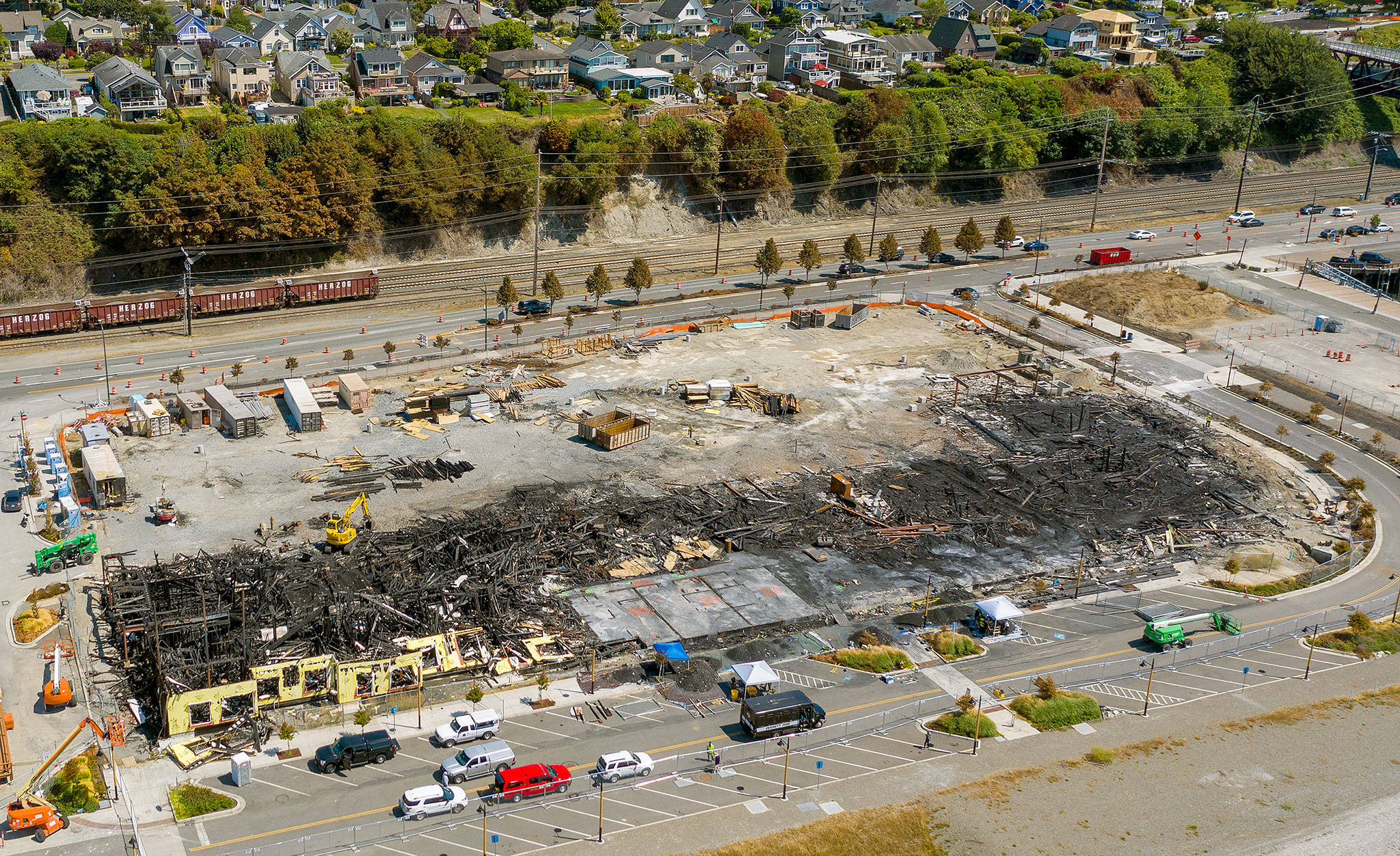 Fire investigators on Tuesday were on the scene of the Waterfront Place Apartments in Everett, which were under construction when they burned July 16. (Chuck Taylor / The Herald)