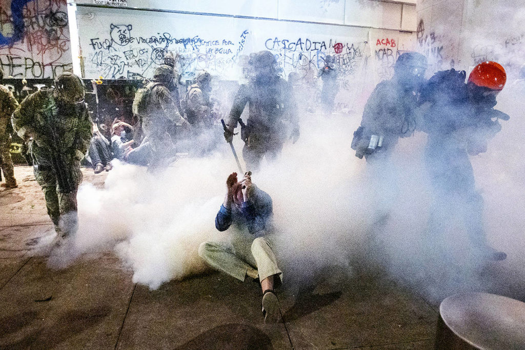 Federal officers use chemical irritants and crowd control munitions to disperse Black Lives Matter protesters outside the Mark O. Hatfield United States Courthouse on Wednesday in Portland, Oregon. (AP Photo/Noah Berger)
