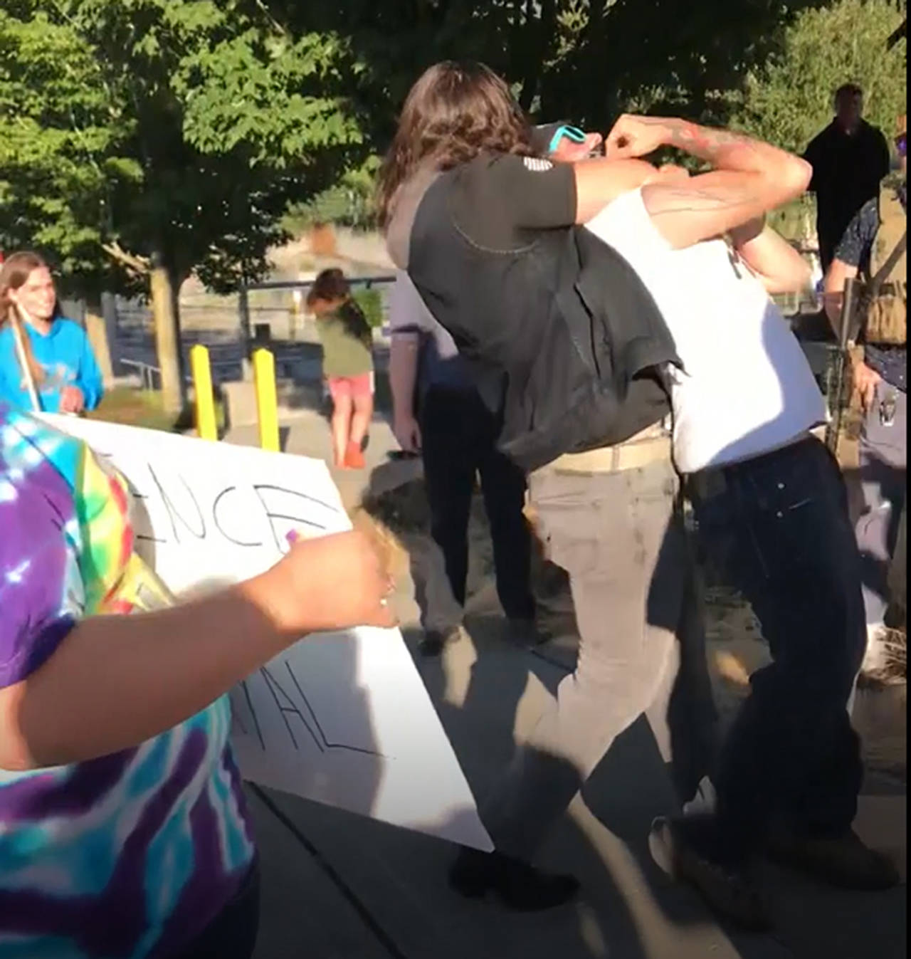 An unidentified man was seen wrapping his arm around a counter-protester and dragging him at the Back the Blue rally in Everett (Screen grab from video courtesy of Ami McCuaig)