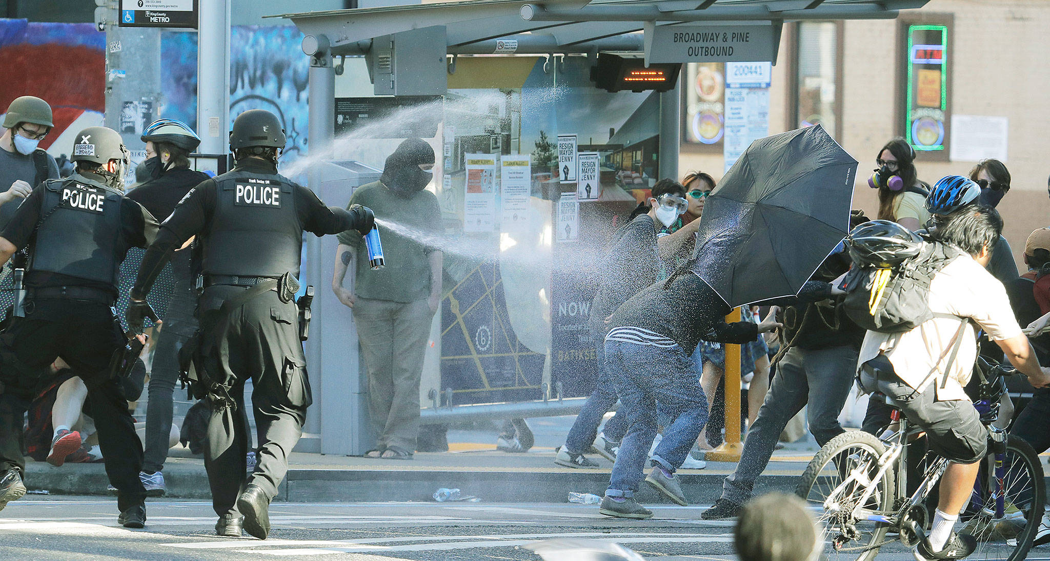 Police pepper-spray protesters Saturday near Seattle Central College in the Capitol Hill neighborhood. (AP Photo/Ted S. Warren)