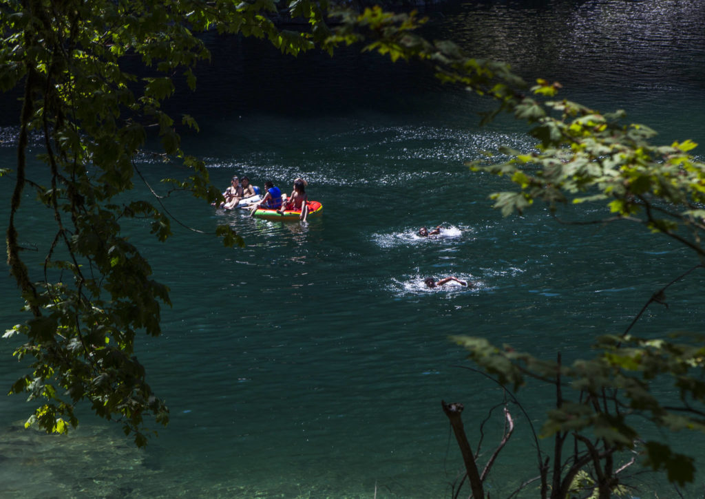 People float and swim at Eagle Falls on Wednesday in Index. (Olivia Vanni / The Herald)
