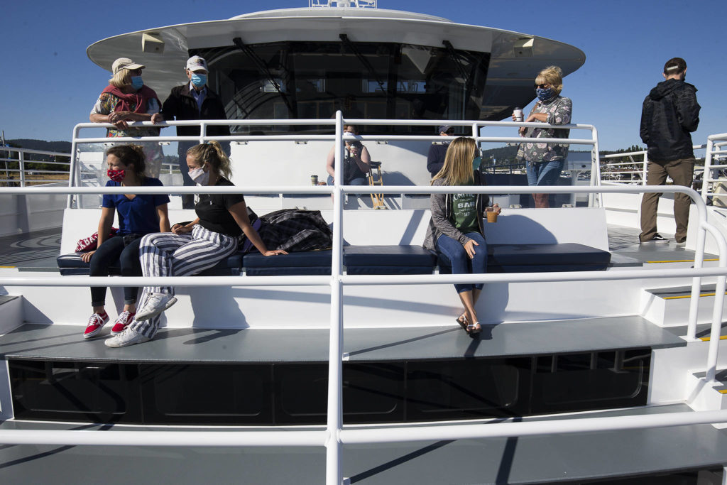 Whale watchers social distance as they get set for a trip on the Island Explorer 5 in Anacortes recently. Island Adventures, a whale watching company, mostly canceled its Everett-based gray whale season. (Andy Bronson / The Herald)
