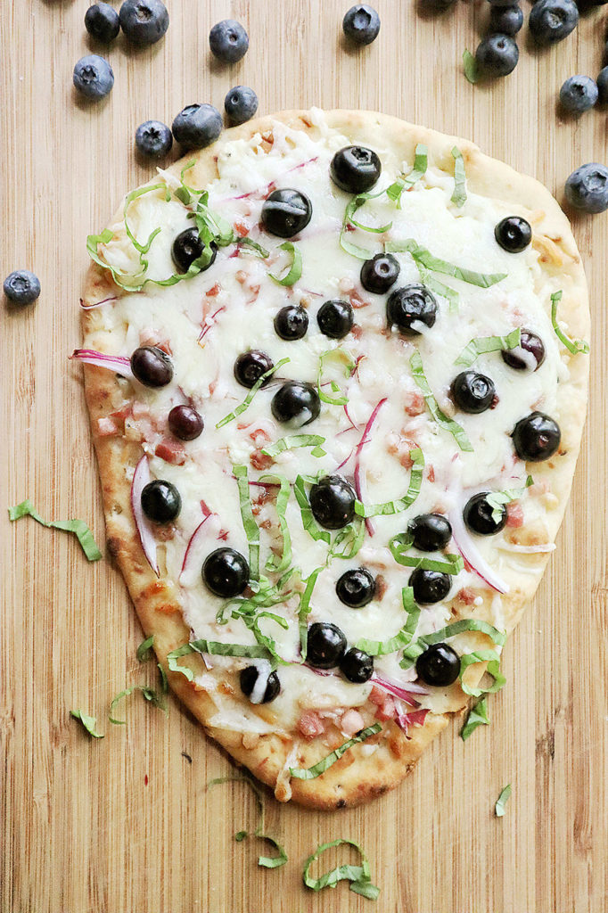 Blueberries add a sweet finish to a savory flatbread topped with mozzarella and gorgonzola cheeses and pancetta. (Gretchen McKay / Pittsburgh Post-Gazette)
