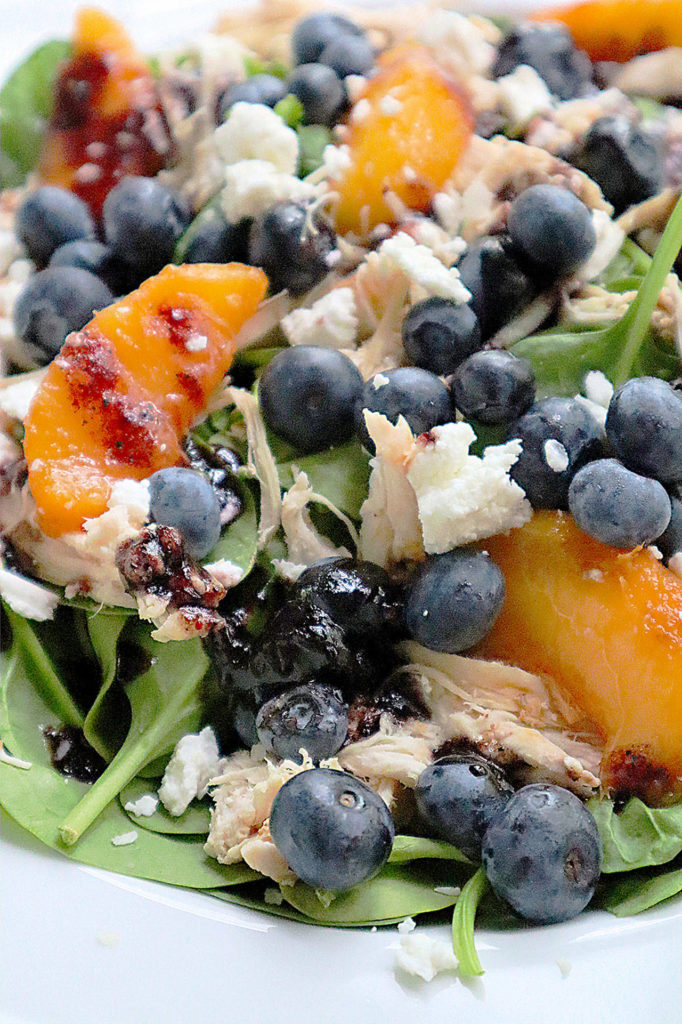 A handful of blueberries add antioxidants to a summer salad tossed with shredded chicken and peaches in a blueberry jam vinaigrette. (Gretchen McKay / Pittsburgh Post-Gazette)
