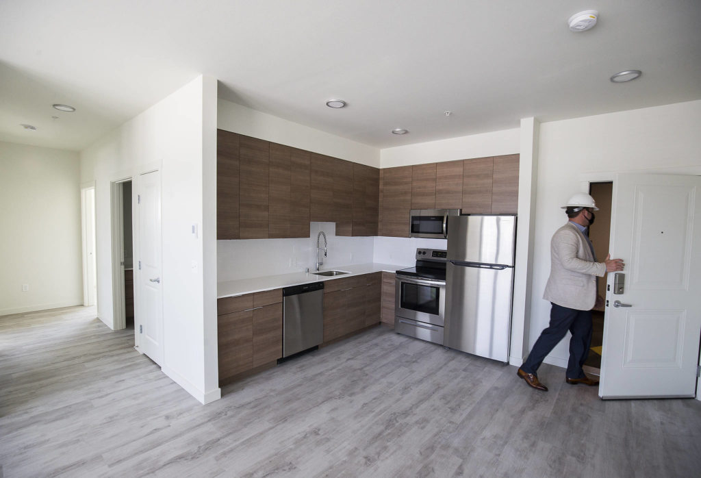 Sean Thorson walks out of a 2-bedroom apartment during a tour of Kinect @ Broadway, an apartment project on Broadway, on Tuesday in Everett. The building is expected to open in September or October. (Andy Bronson / The Herald)
