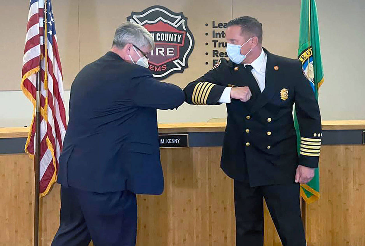 South County Fire Board of Commissioners Chair Jim Kenny swears in Fire Chief Thad Hovis. (South County Fire)