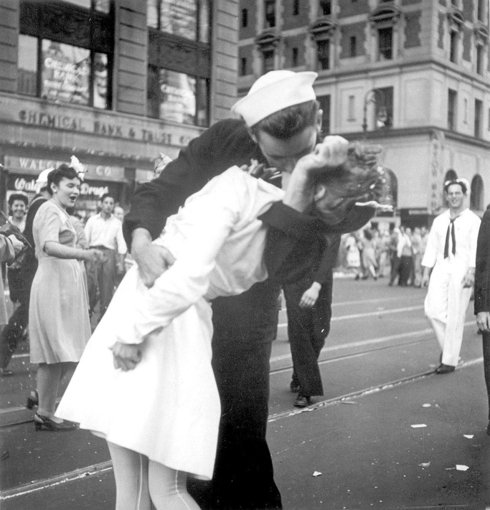 In this Aug. 14, 1945 photo, a sailor and a woman kiss in New York’s Times Square, as people celebrate the end of World War II. It was years after the photo was taken that George Mendonsa, the sailor, and Greta Zimmer Friedman, a dental assistant in a nurse’s uniform, were confirmed to be the couple. (Victor Jorgensen/U.S. Navy, File)
