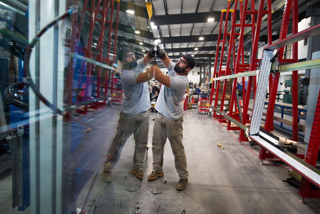 Glazer Nicholas Hawkins cleans a window at Goldfinch Brothers’ new 83,000-square-foot facility on Beverly Park Road in Everett. (Andy Bronson / The Herald)
