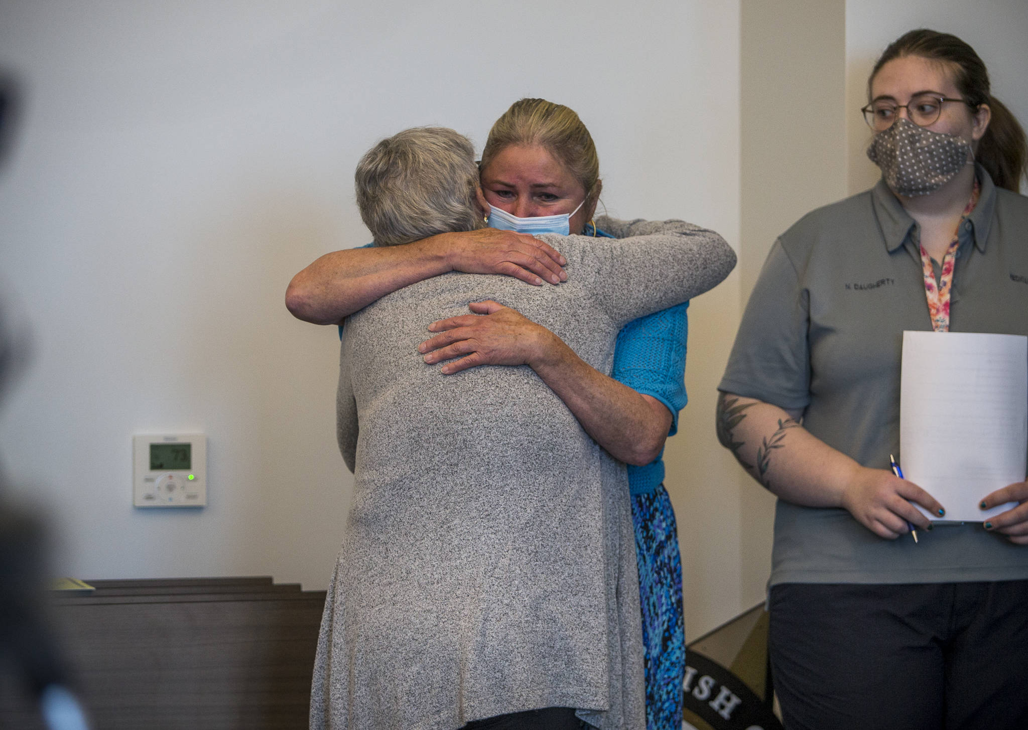 Eleanore “Ellie” Perry (right) hugs Marianne Lambert during a news conference on Wednesday in Everett. Perry is the cousin of Rodney Peter Johnson and Lambert is his sister. (Olivia Vanni / The Herald)