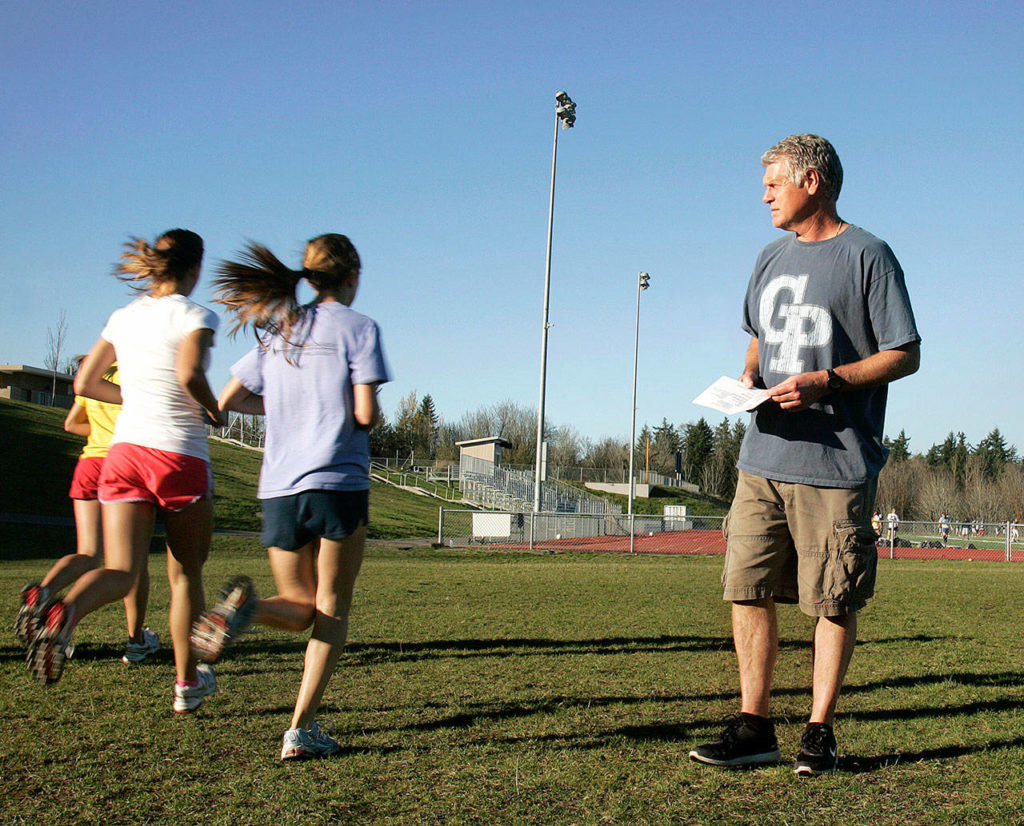 Dan Parker leads the Glacier Peak girls cross country team in drills during practice Nov. 3, 2010, at Glacier Peak High School. (Sarah Weiser / Herald file)
