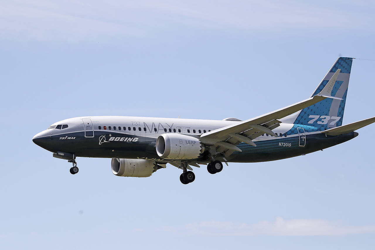 A Boeing 737 Max jet heads to a landing at Boeing Field following a test flight June 29 in Seattle. (AP Photo/Elaine Thompson)