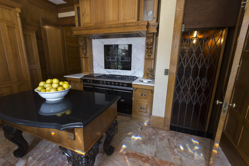 The kitchen in the Rucker Mansion sports an elevator and a marble-engraved backsplash of the house. (Andy Bronson / The Herald)
