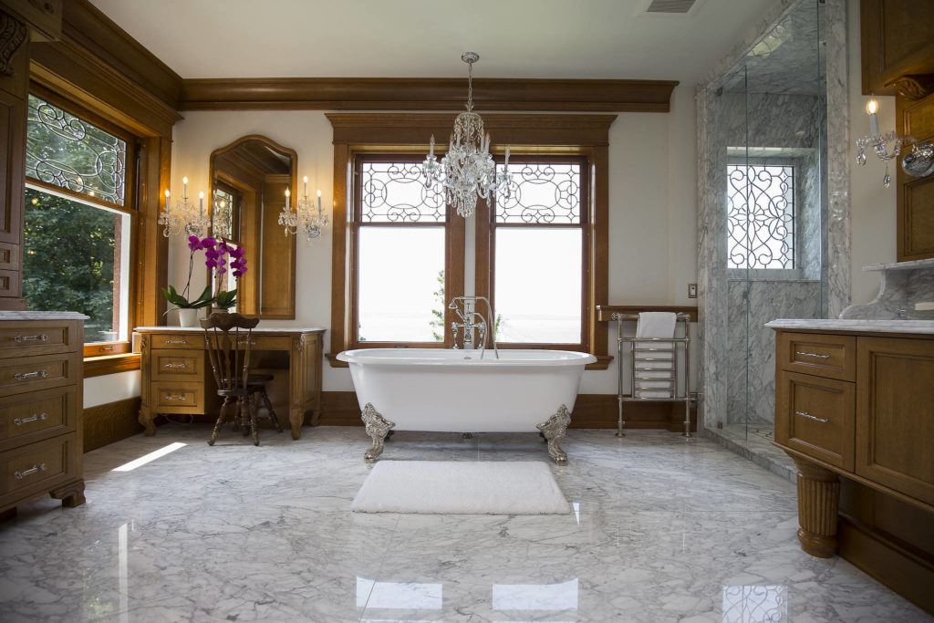 The main bathroom in the Rucker Mansion has marble tiles and a matching tiled shower cut from the same block so the veins line up. (Andy Bronson / The Herald)
