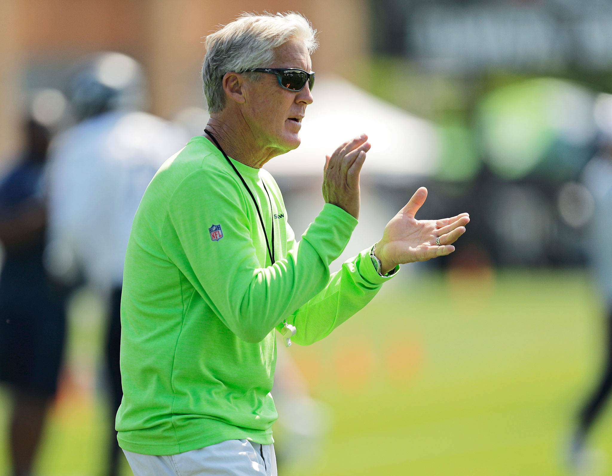 Head coach Pete Carroll and the rest of the Seattle Seahawks hit the field for their first team practice of training camp Wednesday in Renton. (AP Photo/Ted S. Warren)