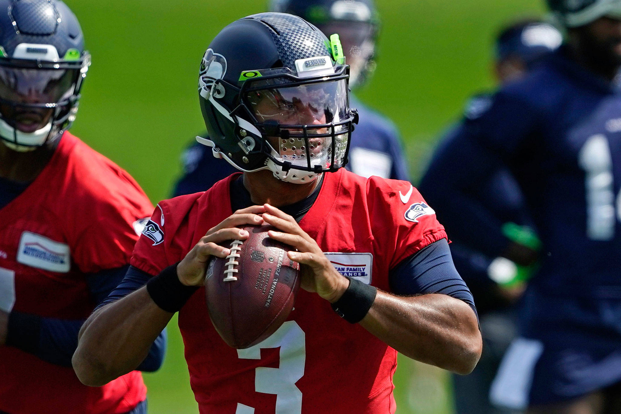 Seahawks quarterback Russell Wilson looks to pass during a training-camp practice Aug. 12, 2020, in Renton. (AP Photo/Ted S. Warren)