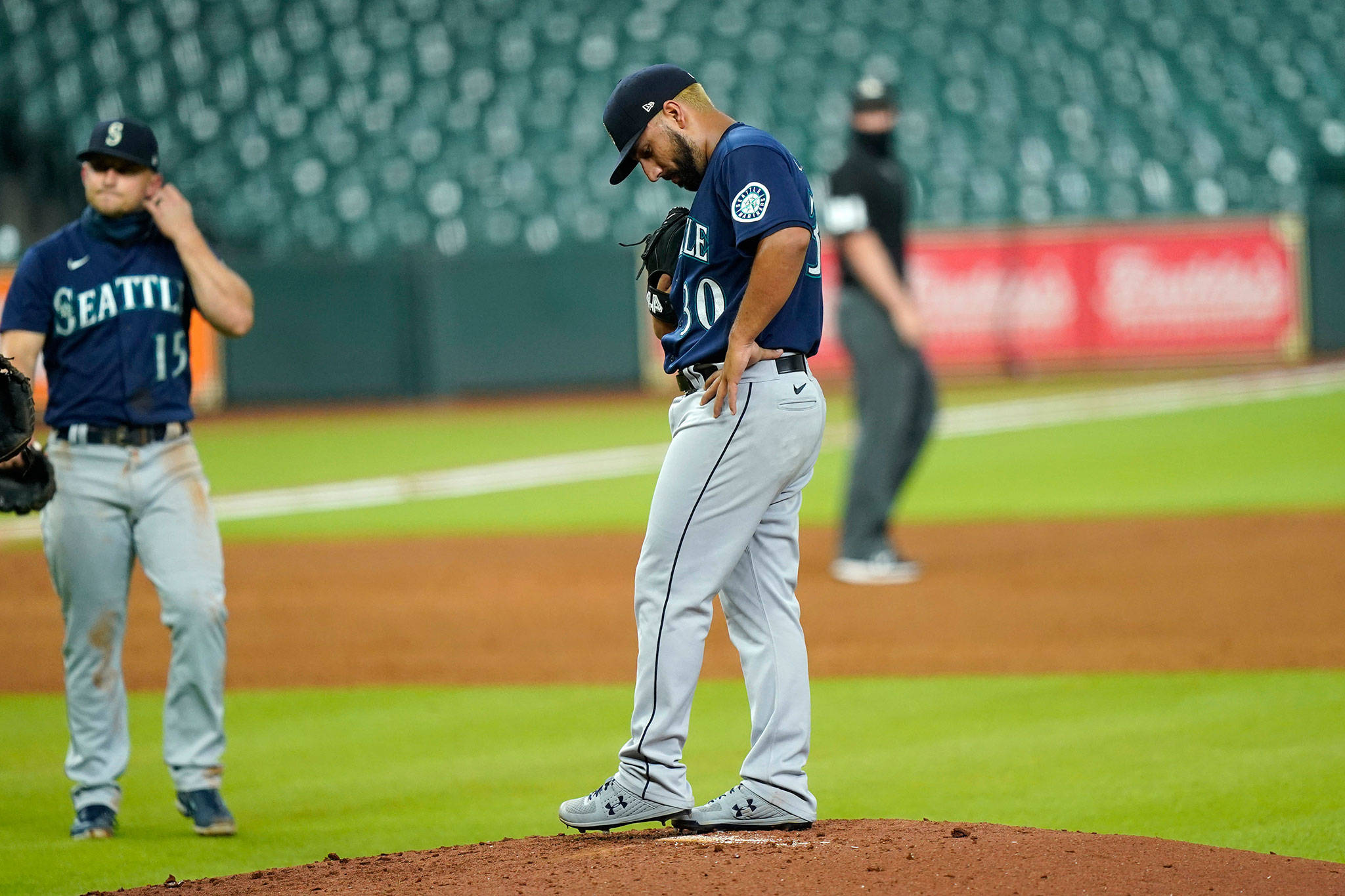 Mariners starting pitcher Nestor Cortes (30) waits for manager Scott Servais to make his way to the mound to pull him during the first inning of a game against the Astros on Aug. 14, 2020, in Houston. (AP Photo/David J. Phillip)