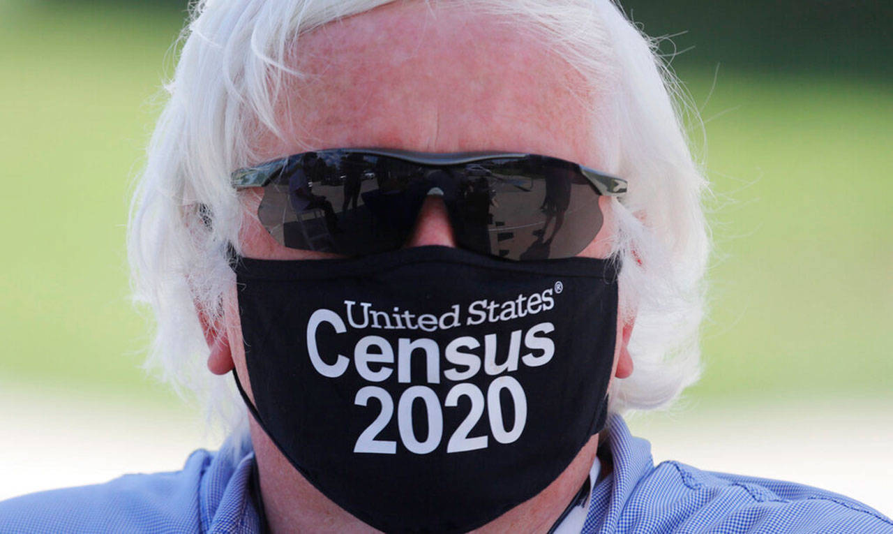 Amid concerns of the spread of COVID-19, census worker Ken Leonard wears a mask as he staffs a U.S. Census walk-up counting site set up for Hunt County in Greenville, Texas, on July 31. (LM Otero / Associated Press)