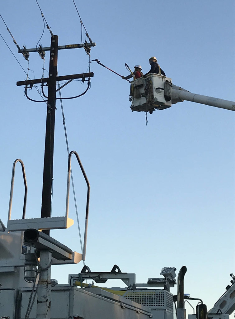 Snohomish County PUD linemen make repairs to a pole cut by vandals along the Interurban Trail in Lynnwood. All four damaged power poles were replaced. (Snohomish County PUD)
