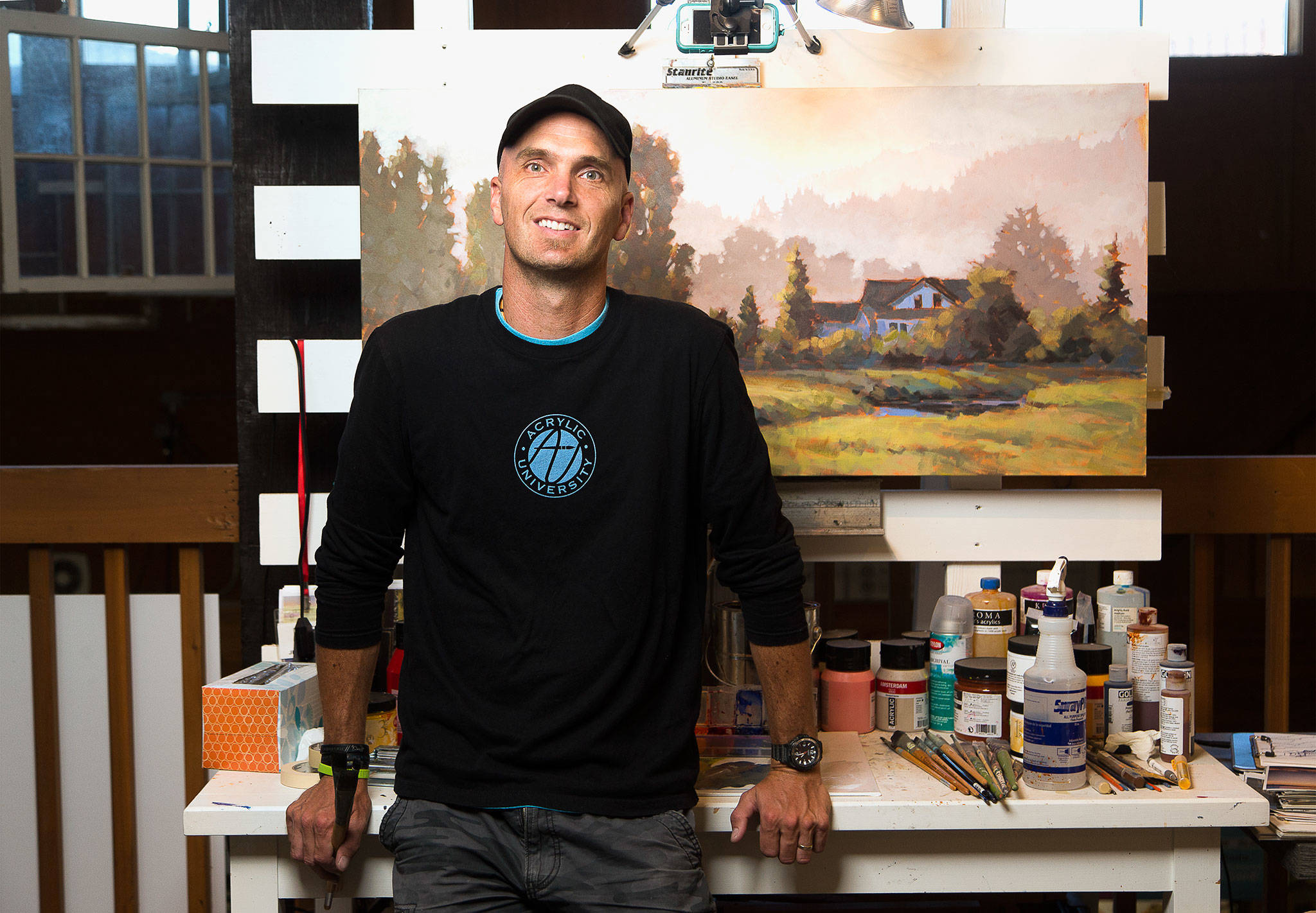 Painter Jed Dorsey works on a piece in the Jed Dorsey Fine Art Studio at Camano Commons. (Andy Bronson / The Herald)